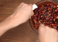 This Lady Mixes Baking Soda And Peanuts In A Dish