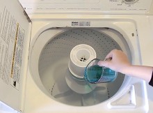 Pouring Some Mouthwash Into The Washing Machine