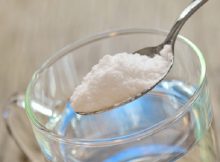 Spoonful of baking soda and glass of water