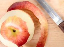 Red apple, peel and knife